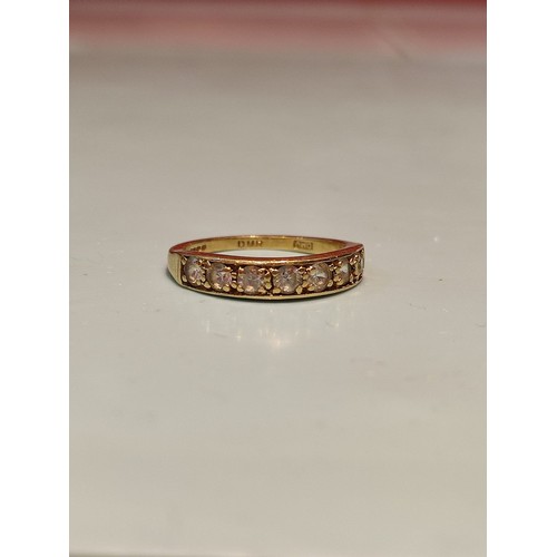 156 - 18ct gold ring adorned with seven diamonds. Size R and 2.8grams gross. Stamped with London hallmark ... 