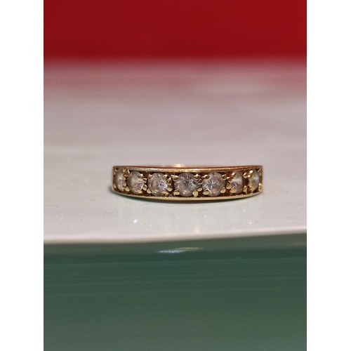 156 - 18ct gold ring adorned with seven diamonds. Size R and 2.8grams gross. Stamped with London hallmark ... 