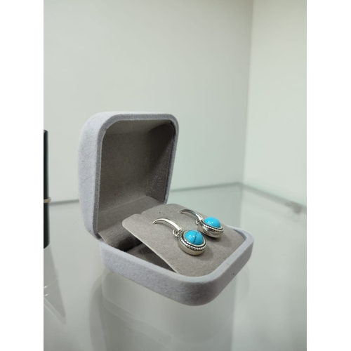 133 - Designer silver earrings with turquoise  earrings in box. The earrings are stamped 925 and have the ... 