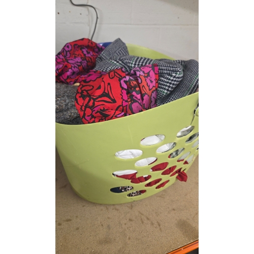 97 - A Collection of Clothing in a Plastic Laundry Basket