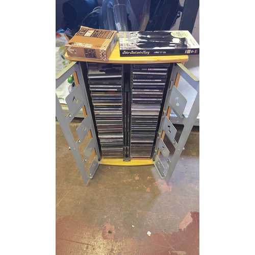 117 - A Collection of Music CDs Housed within a Two-Tier Wooden and Metal Storage Cabinet