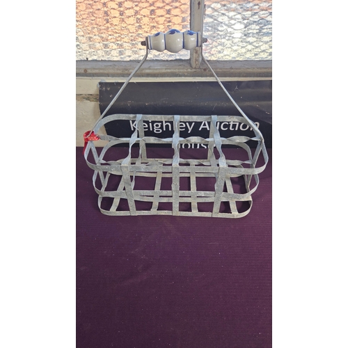 67 - A vintage galvanised metal six-compartment bottle carrier with ceramic handle