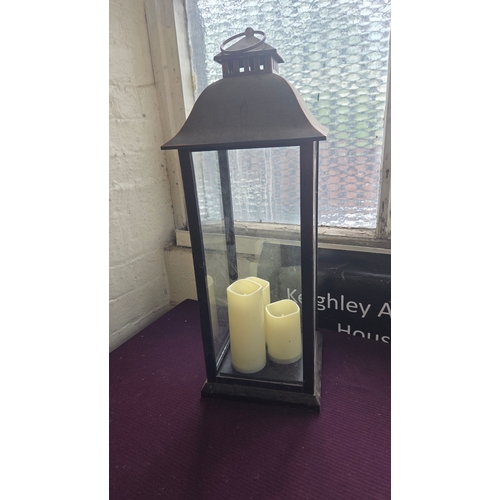 192 - A Contemporary Metal and Glass Floor Lantern with Flameless LED Candles