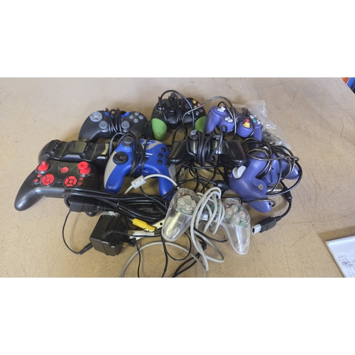 246 - An Assortment of Video Game Controllers and Accessories for Xbox, PlayStation and GameCube Consoles