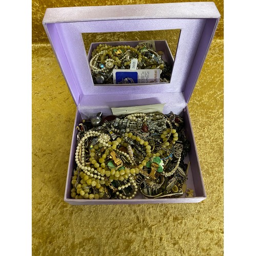 16 - A purple satin box of costume jewellery