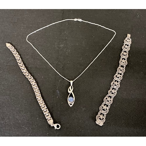 11 - Silver and Lapis Lazuli Pendant on chain together with two silver bracelets