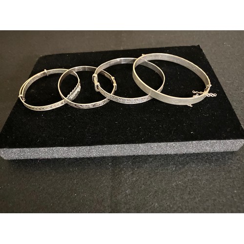 12 - Four decorated silver child's bracelets