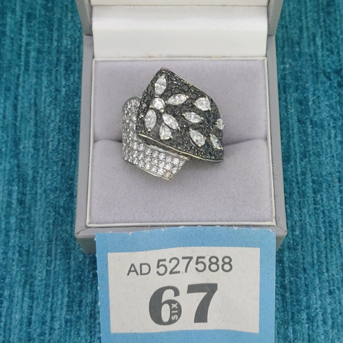 67 - Black and White Diamond Cluster Dress Ring
- 18ct White Gold
- 17.4g