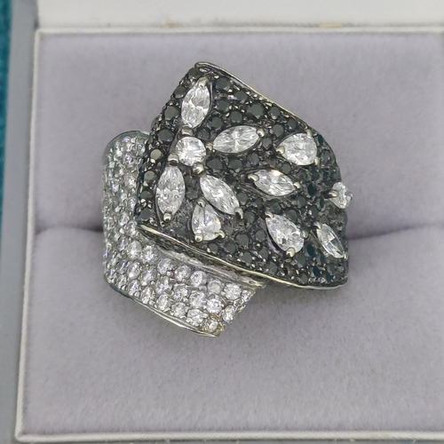 67 - Black and White Diamond Cluster Dress Ring
- 18ct White Gold
- 17.4g