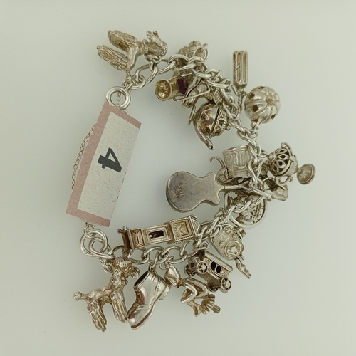 4 - This is a lovely Silver Charm Bracelet which is packed with charms and very heavy.
- weight 83 g
- c... 