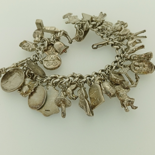 16 - Here we have the second of our Silver Charm Bracelets.  This is a very heavy bracelet crammed with c... 