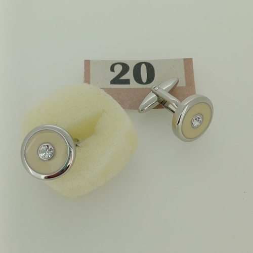 20 - Cuff links . Silver Metal with a White/cream insert with a diamond effect stone