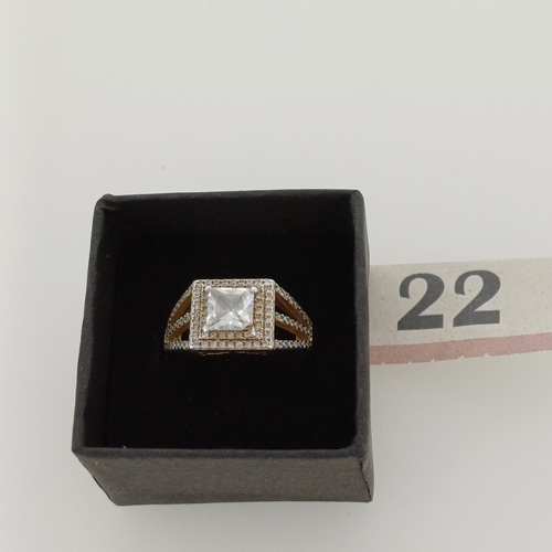 22 - Silver Ring with a square cut center stone with encrusted stones around.

Size M