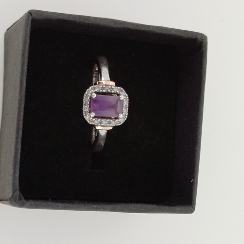 24 - Ladies Gold Ring with Purple Stone and White Stone surround.
- 9 ct Gold
- weight 2.6 g