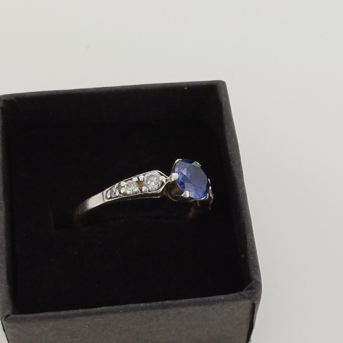 25 - Ladies Gold Ring with Blue Stone (possibly Sapphire) with White Stones
- 9 ct Gold
- weight 2 g