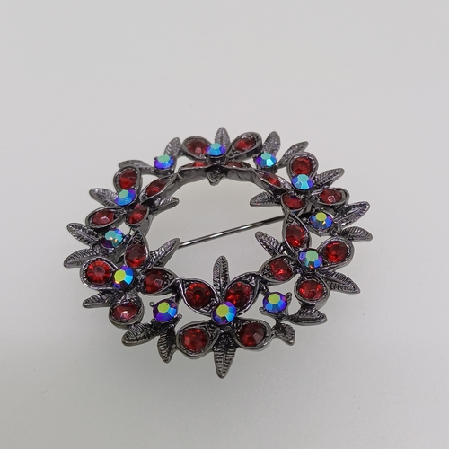 68 - Here we have a very pretty brooch with multi colour and red stones and an unusual ring both are grea... 