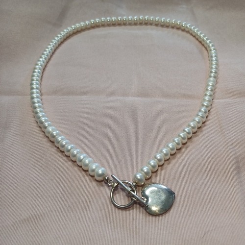 240 - A Natural Pearl Necklace and Bracelet Set with a Silver Heart and Loop Catch.