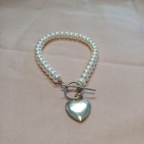 240 - A Natural Pearl Necklace and Bracelet Set with a Silver Heart and Loop Catch.