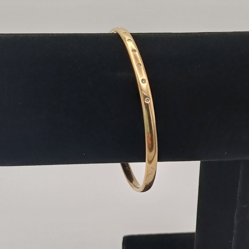 13 - A very lovely Gold Bangle with inset Diamonds.
- weight 15.65g
- 9ct yellow gold