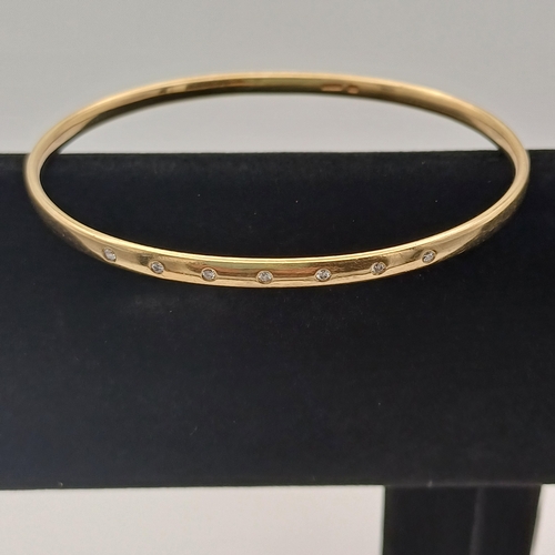 13 - A very lovely Gold Bangle with inset Diamonds.
- weight 15.65g
- 9ct yellow gold