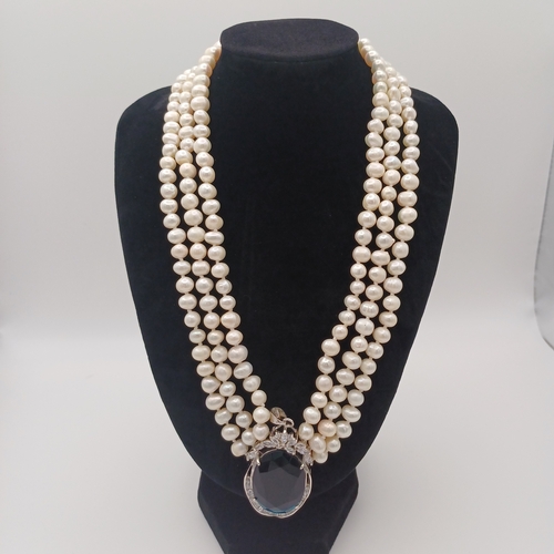 18 - Here we have a three strand Pears Necklace with a vey Dark Blue Stone.  A lovely dress piece.