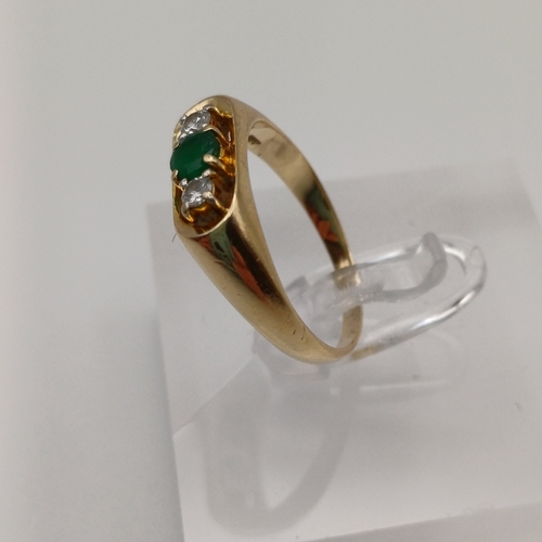 25 - A Three Stone Emerald and Diamond Ring. In an unusual setting and the Emerald is really beautiful de... 