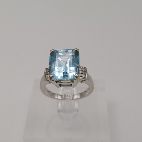 36 - An Aquamarine and Diamond Ring.  Each side of this stunningly beautiful Aquamarine are Diamonds set ... 