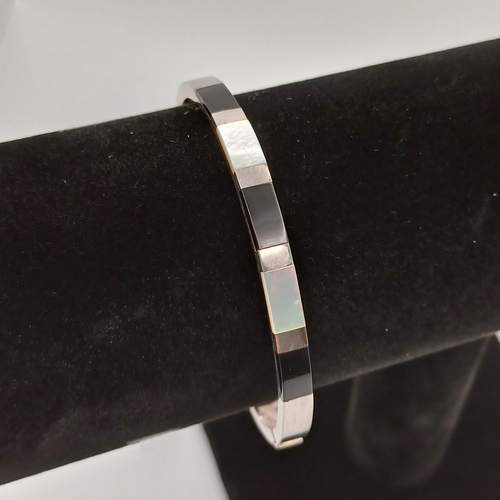 38 - Pretty Mother of Pearl and Onyx Bangle on a silver colour metal