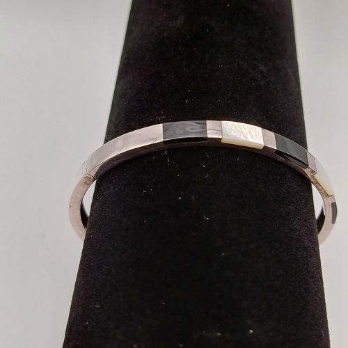 38 - Pretty Mother of Pearl and Onyx Bangle on a silver colour metal