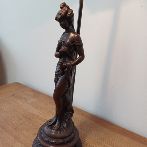 93 - Very pretty table lamp in cold bronze of a lady standing under the lamp.