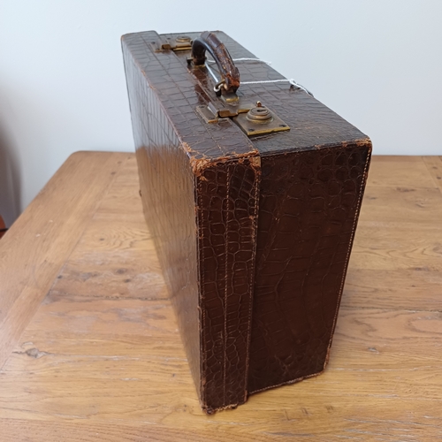 95 - An Antique Crocodile Case.  The interior is in very good condition.  It has a key and the locks are ... 