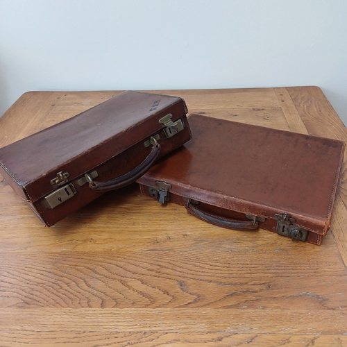 96 - Two heavy leather cases in a used condition