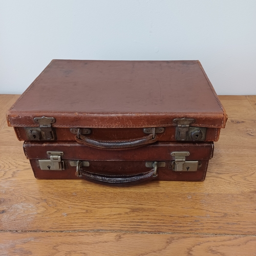 96 - Two heavy leather cases in a used condition