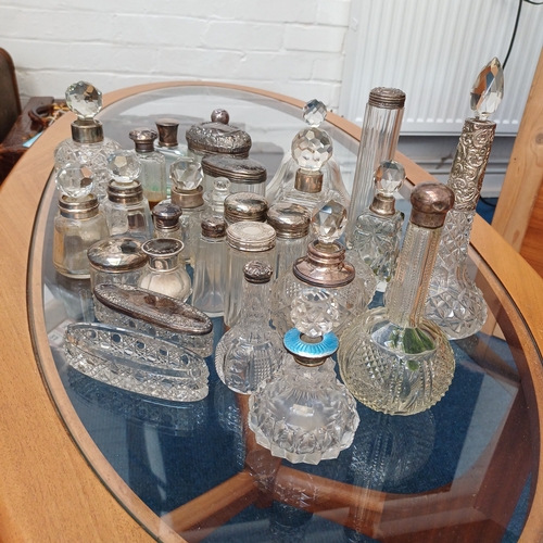 100 - A mixed set of cut glass/crystal vanity bottles the majority with stoppers all, save a couple, have ... 