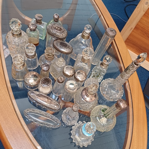 100 - A mixed set of cut glass/crystal vanity bottles the majority with stoppers all, save a couple, have ... 