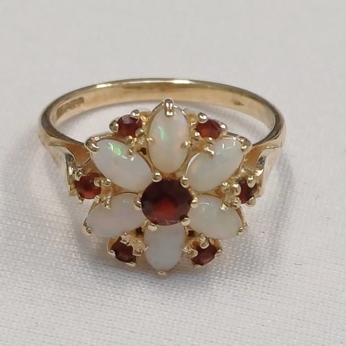 110 - The colours in the Opals of this ring are truly stunning and complimented by the deep Garnet Stones.... 