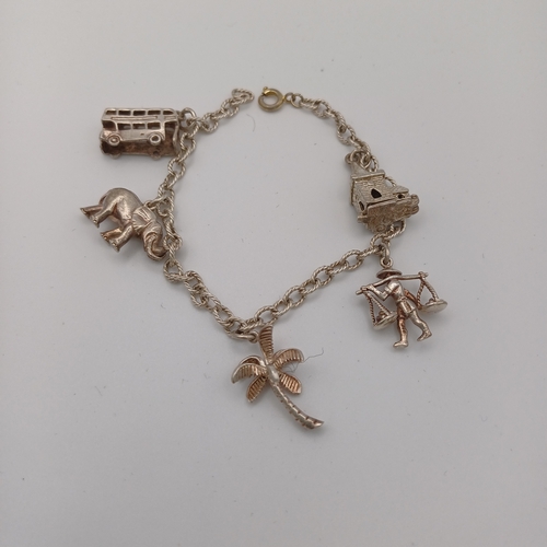 39 - Silver Charm Bracelet with 5 Charms - bus, elephant, church, flower and man with scales.
- weight 18... 