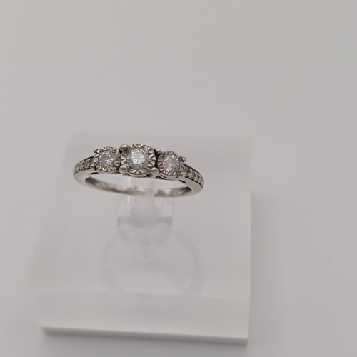 87 - Pretty three stone Diamond Ring with Diamonds set into the shoulder each side of the shank.
- size J... 