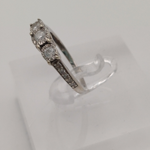 87 - Pretty three stone Diamond Ring with Diamonds set into the shoulder each side of the shank.
- size J... 