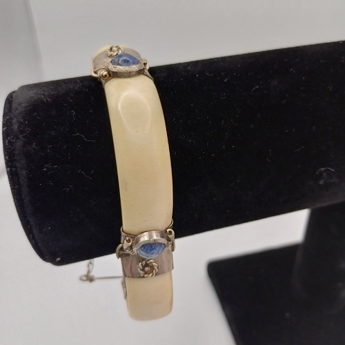 100 - Here we have a Bone Hinged Bangle with Cabochon Kyanite Blue Stones set in.  This is unusual Bangle ... 