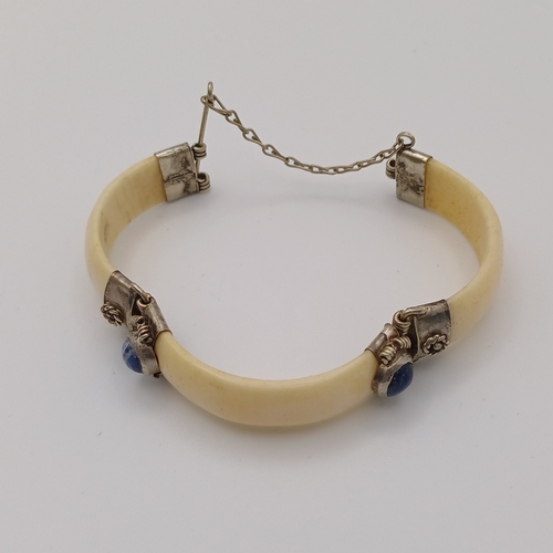 100 - Here we have a Bone Hinged Bangle with Cabochon Kyanite Blue Stones set in.  This is unusual Bangle ... 