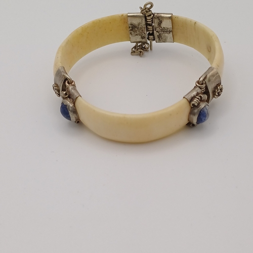 100 - Here we have a Bone Hinged Bangle with Cabochon Kyanite Blue Stones set in.  This is unusual Bangle ... 