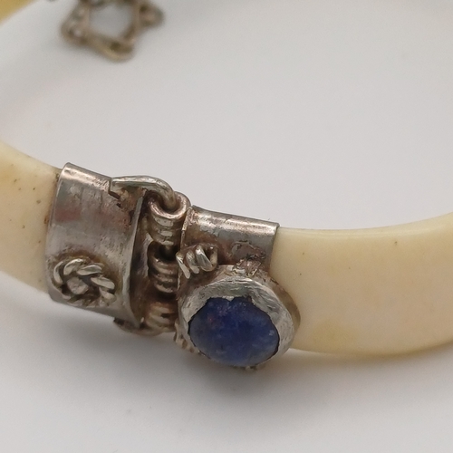 100 - Here we have a Bone Hinged Bangle with Cabochon Kyanite Blue Stones set in.  This is unusual Bangle ... 