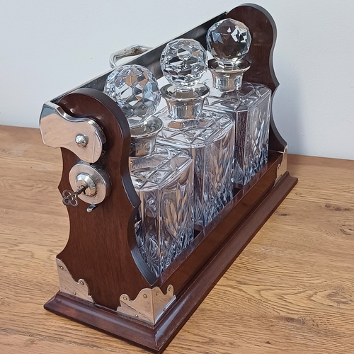 23 - This is a really stunning Three Decanter Tantalus.  This in excellent condition and comes with key w... 