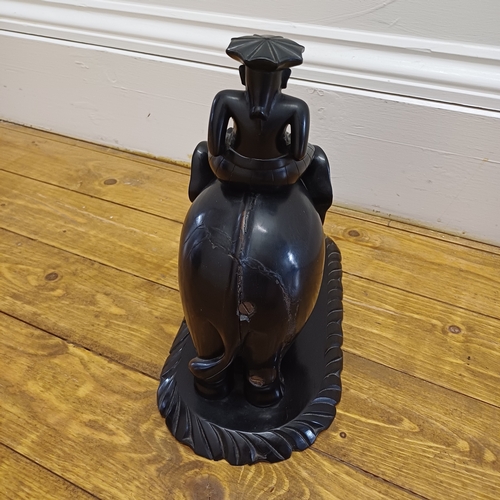 47 - A very striking Ebony Carved Elephant with Rider which is mounted on an Ebony Plinth.  There is a li... 