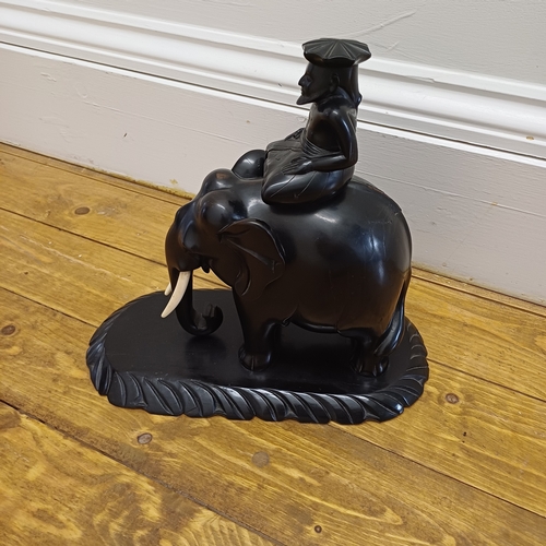 47 - A very striking Ebony Carved Elephant with Rider which is mounted on an Ebony Plinth.  There is a li... 