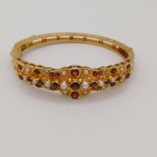 113 - An absolutely stunning 1970's heavily engraved hinged bangle set with Rose Cut Garnet and Cultured S... 