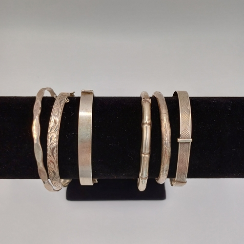 124 - Six Silver Bangles:
- 4 x hinged
- 1 slip on 
- 1 x expanding

All are marked either 925 or are hall... 