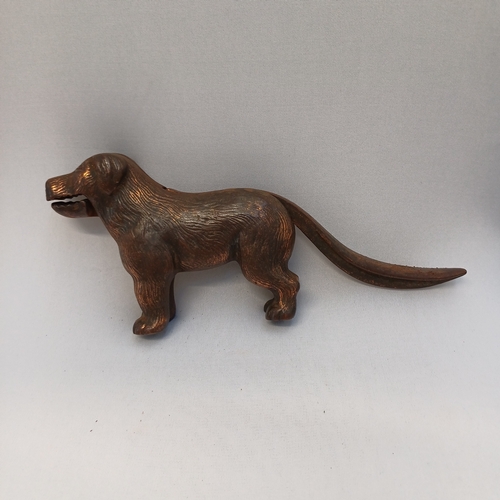 64 - 1940's Nutcracker in the shape of a dog, so when you lift his tail he opens his mouth and you push i... 