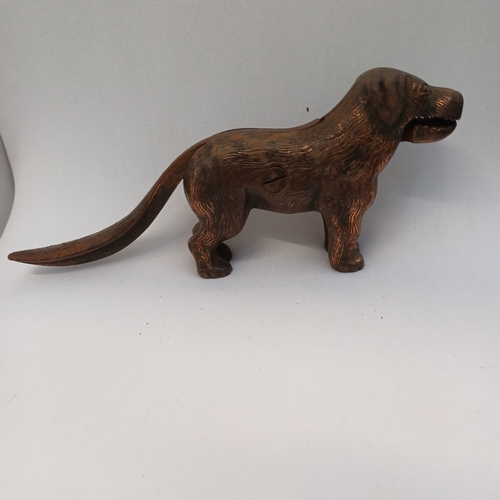 64 - 1940's Nutcracker in the shape of a dog, so when you lift his tail he opens his mouth and you push i... 